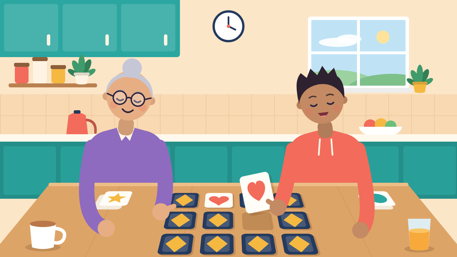 An older adult and a teenager playing a memory card matching game together at a kitchen table